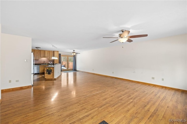 unfurnished living room with ceiling fan and light hardwood / wood-style floors