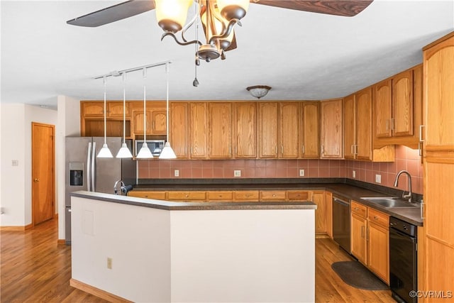 kitchen featuring a center island, appliances with stainless steel finishes, sink, and light hardwood / wood-style floors