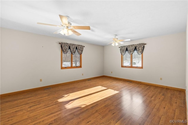 empty room with hardwood / wood-style flooring and ceiling fan