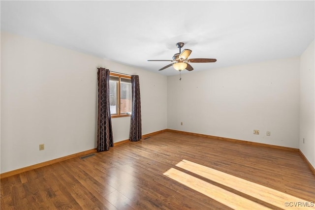 spare room with wood-type flooring and ceiling fan