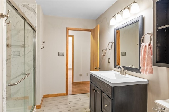 bathroom featuring walk in shower and vanity