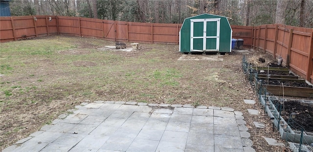 view of yard with a fire pit and a shed