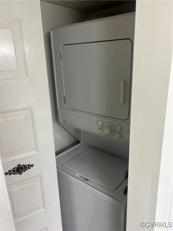 laundry area featuring stacked washer and clothes dryer