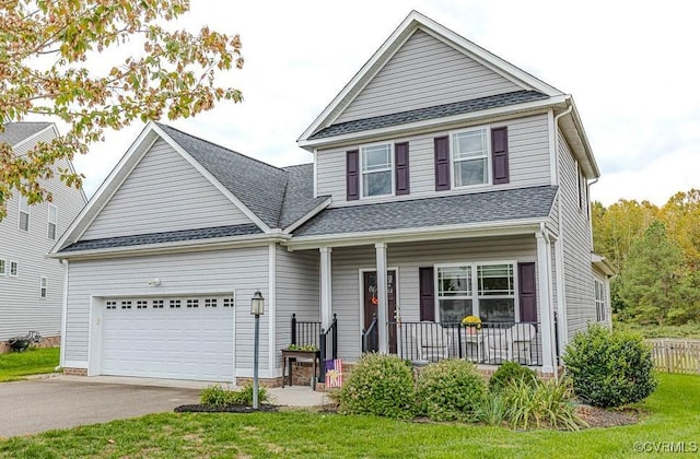 view of front of property with covered porch, a front yard, and a garage