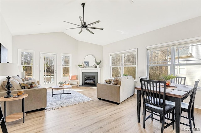 living room with ceiling fan, a healthy amount of sunlight, and light wood-type flooring