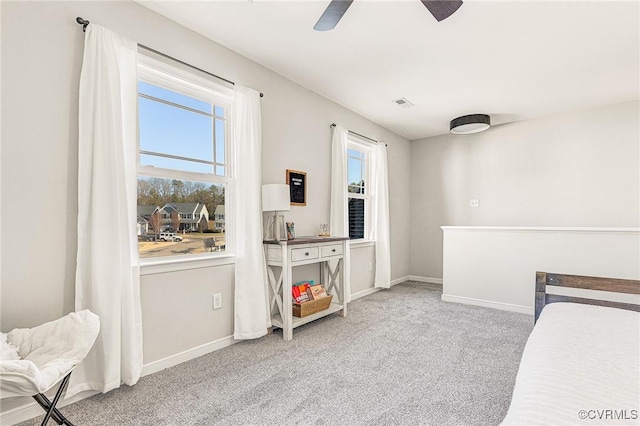 bedroom with ceiling fan, multiple windows, and carpet flooring