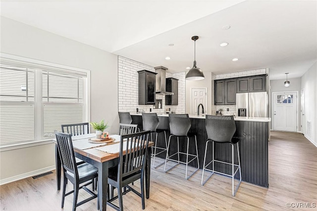 dining space with light hardwood / wood-style floors and a wealth of natural light