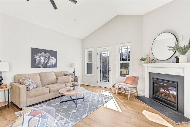 living room with high vaulted ceiling and hardwood / wood-style floors