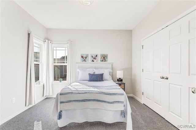 bedroom with a closet and dark carpet