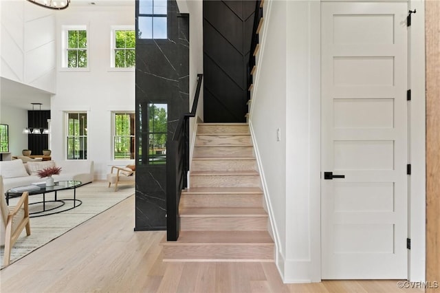 stairs with wood finished floors and baseboards