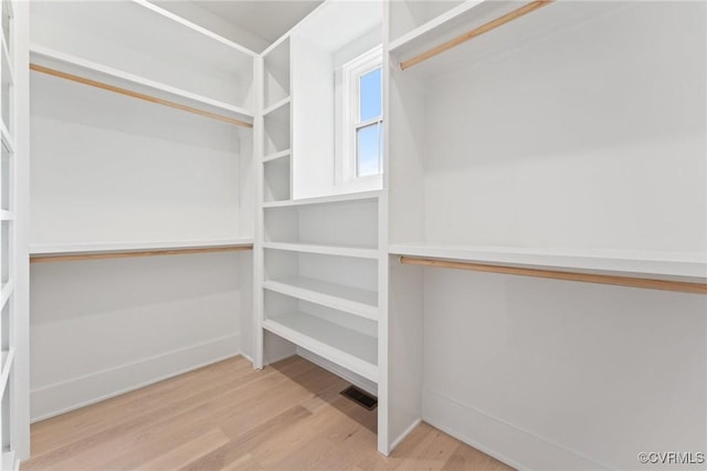 walk in closet with wood finished floors and visible vents