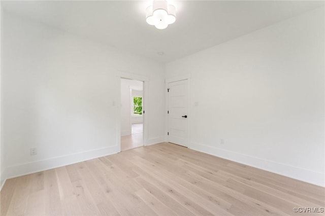 unfurnished room with light wood-style floors and baseboards