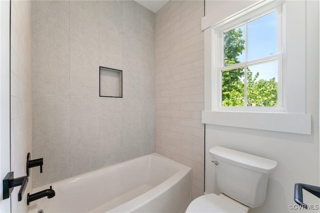 bathroom with washtub / shower combination and toilet