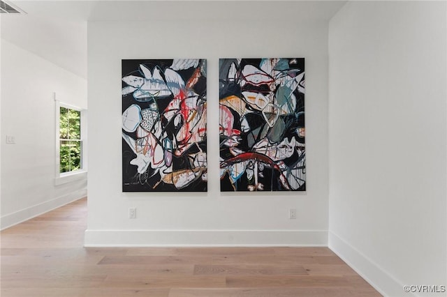 interior details featuring wood finished floors, baseboards, and visible vents