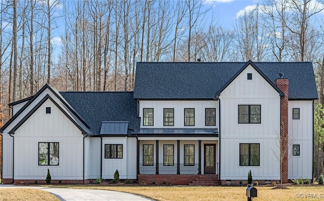 modern inspired farmhouse with board and batten siding, crawl space, a shingled roof, and a front lawn