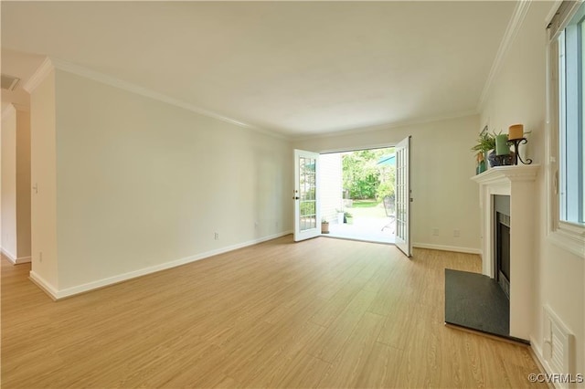 unfurnished living room with ornamental molding and light wood-type flooring