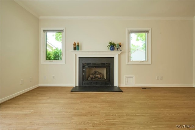 unfurnished living room with ornamental molding, a healthy amount of sunlight, and light hardwood / wood-style floors