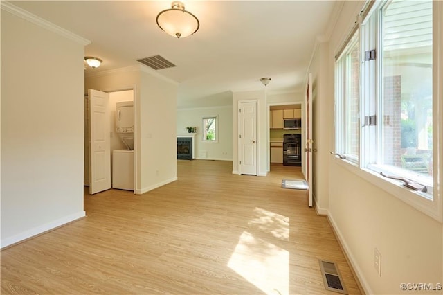 hallway featuring crown molding, a wealth of natural light, and light wood-type flooring