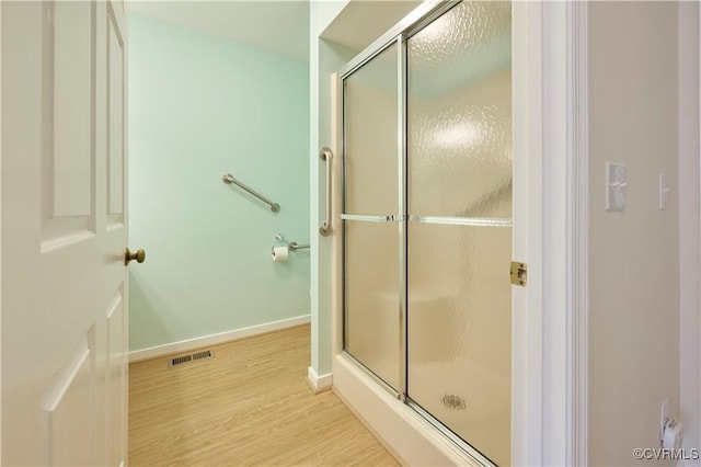 bathroom with walk in shower and hardwood / wood-style flooring