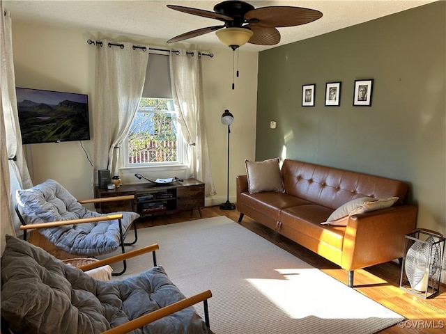 living room featuring ceiling fan and wood-type flooring