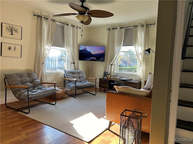 sitting room featuring ceiling fan and wood-type flooring