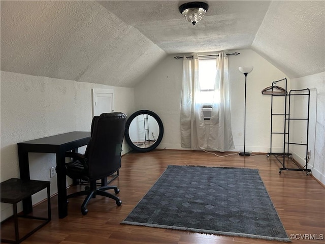 office space featuring vaulted ceiling, dark wood-type flooring, and a textured ceiling