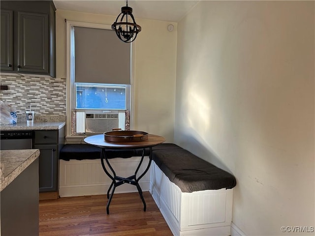 dining space with cooling unit, dark hardwood / wood-style floors, and a chandelier