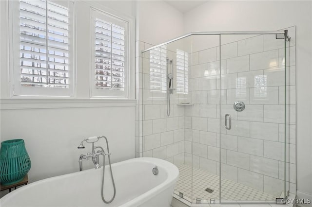 bathroom with separate shower and tub