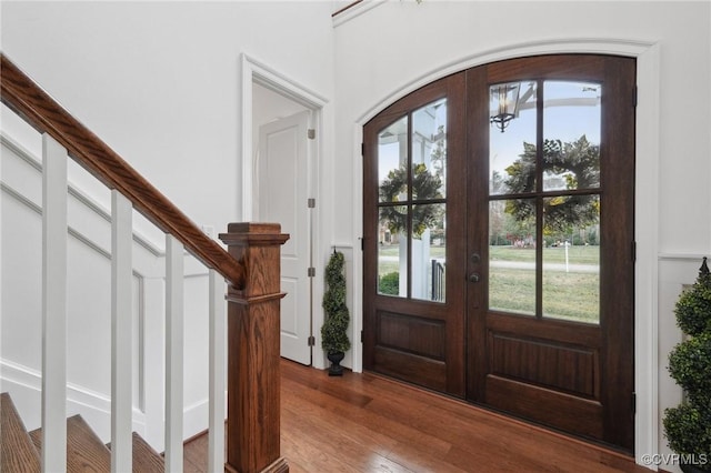 entryway with hardwood / wood-style flooring, plenty of natural light, and french doors