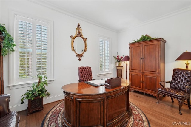 office space with light hardwood / wood-style flooring and ornamental molding