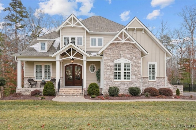 craftsman-style home with a front lawn, french doors, and a porch