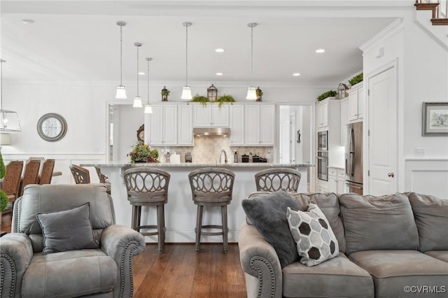 living room with ornamental molding and dark hardwood / wood-style floors