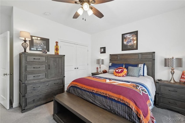 carpeted bedroom with ceiling fan and a closet