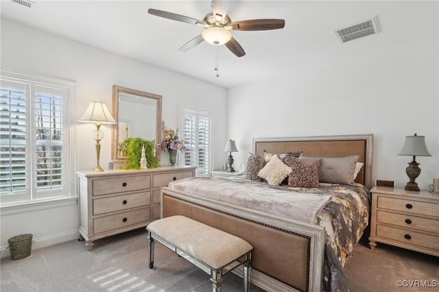 bedroom featuring multiple windows, carpet floors, and ceiling fan