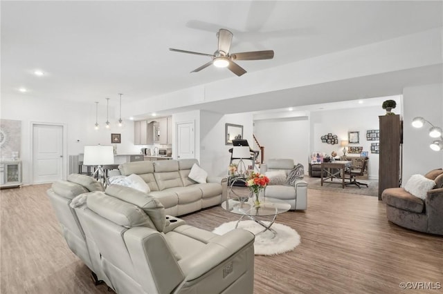 living room with hardwood / wood-style flooring and ceiling fan