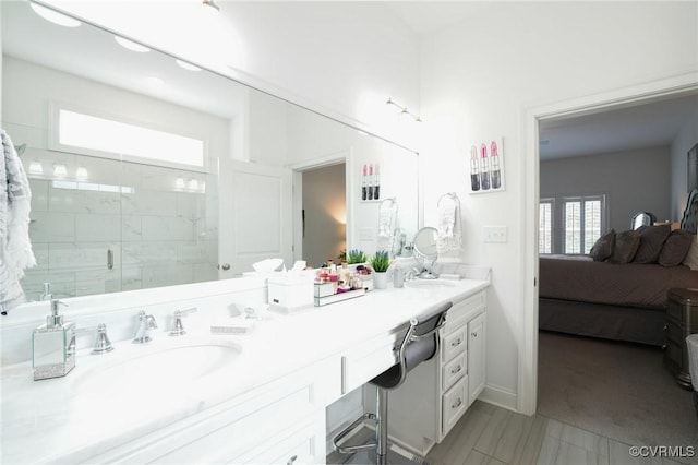 bathroom with vanity and a shower with door