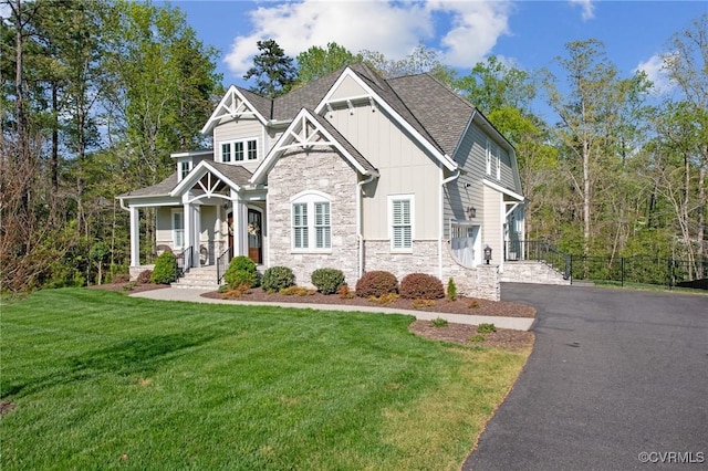 11513 Barrows Ridge Ln, Chesterfield, VA 23838 - view of front of home featuring a front lawn, driveway, stone siding, board and batten siding, and roof with shingles