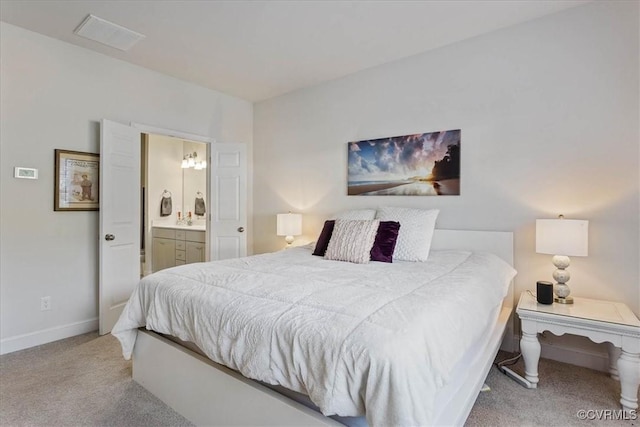 carpeted bedroom with ensuite bath