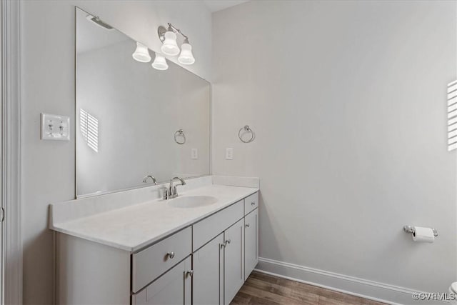 bathroom featuring hardwood / wood-style flooring and vanity