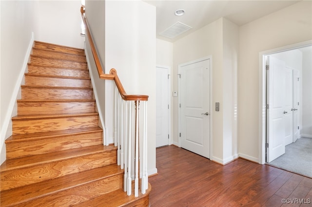 stairs with hardwood / wood-style floors