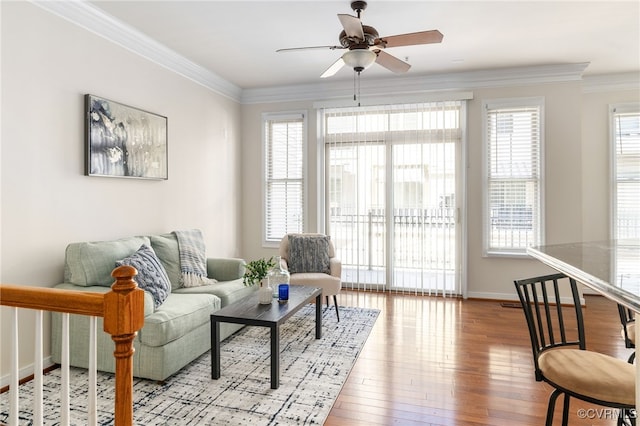 living room with crown molding, light hardwood / wood-style floors, and ceiling fan