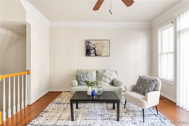 living room featuring crown molding, plenty of natural light, and wood-type flooring