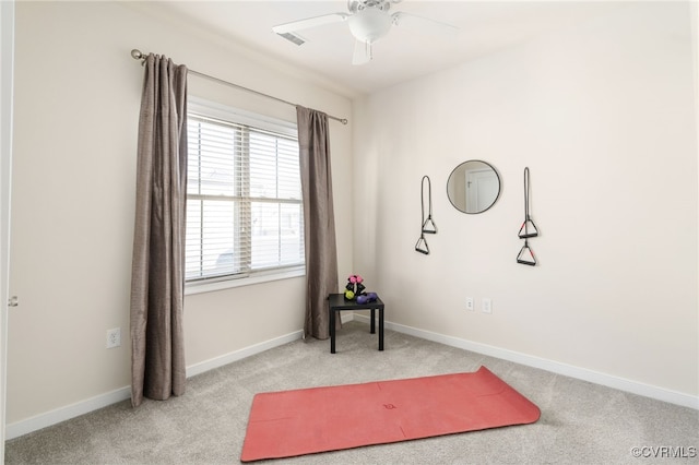 interior space featuring ceiling fan and light colored carpet