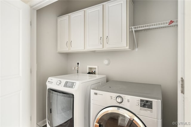 laundry room with cabinets and washing machine and dryer