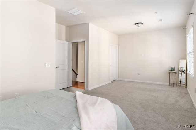 carpeted bedroom featuring multiple windows