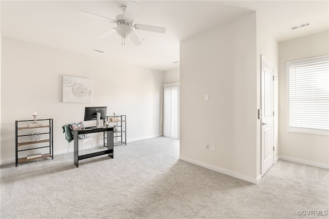 interior space with light colored carpet and ceiling fan