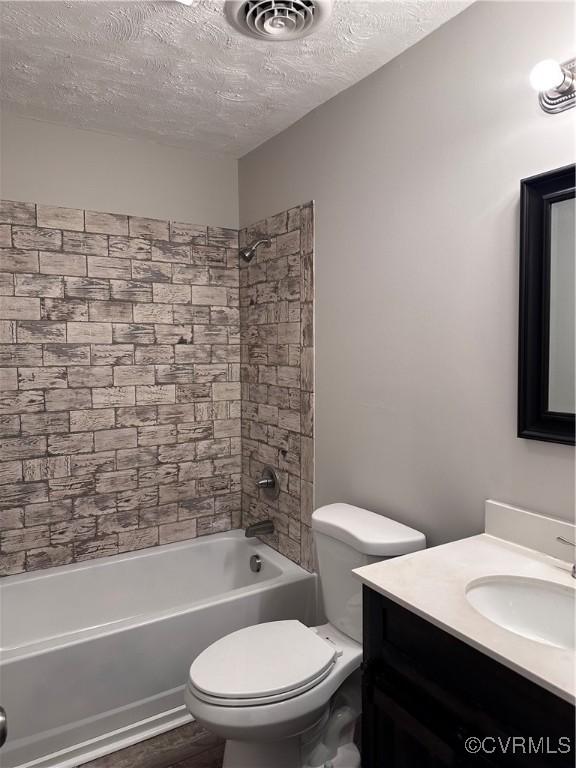 full bathroom with toilet, bathing tub / shower combination, a textured ceiling, vanity, and hardwood / wood-style floors