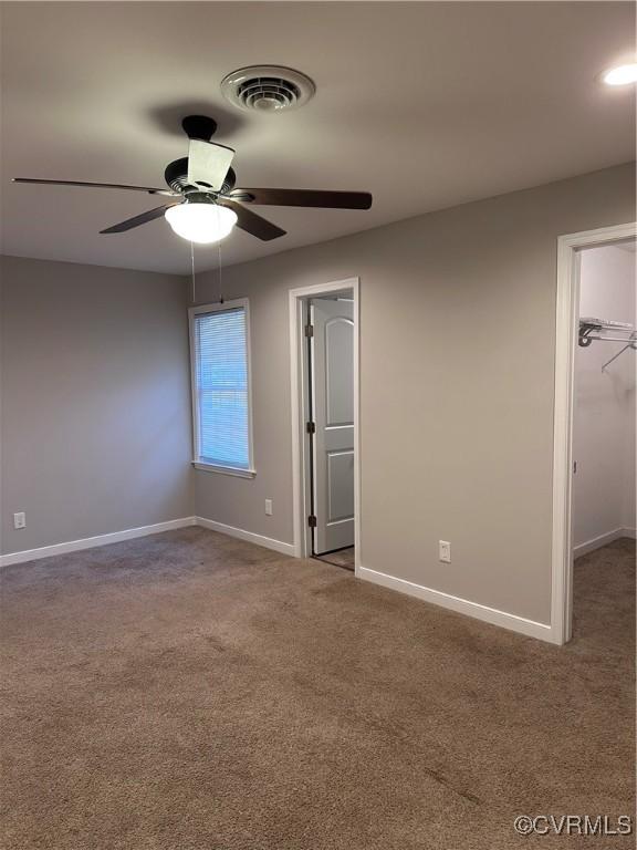 carpeted empty room with ceiling fan