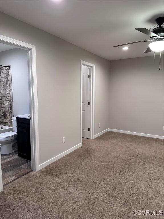 carpeted spare room with ceiling fan