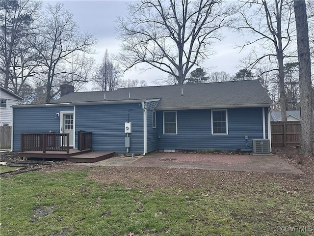 back of property featuring central AC, a deck, a patio area, and a lawn